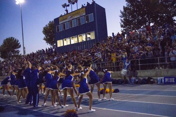 Student fan section and supporters follow cheerleaders in the Warrior Coaster during the win against the Alta Hawks on September 19.