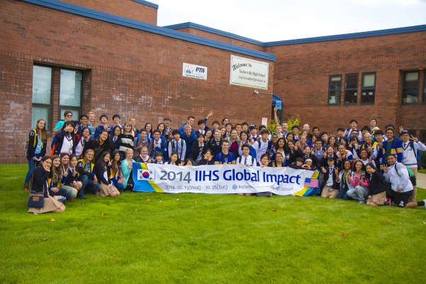 The+Korean+students+stand+outside+of+the+school+with+their+hosts+for+a+group+picture.