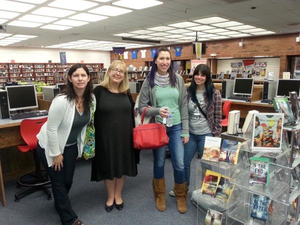 Four of the authors who visited our school pose for a picture in the library.