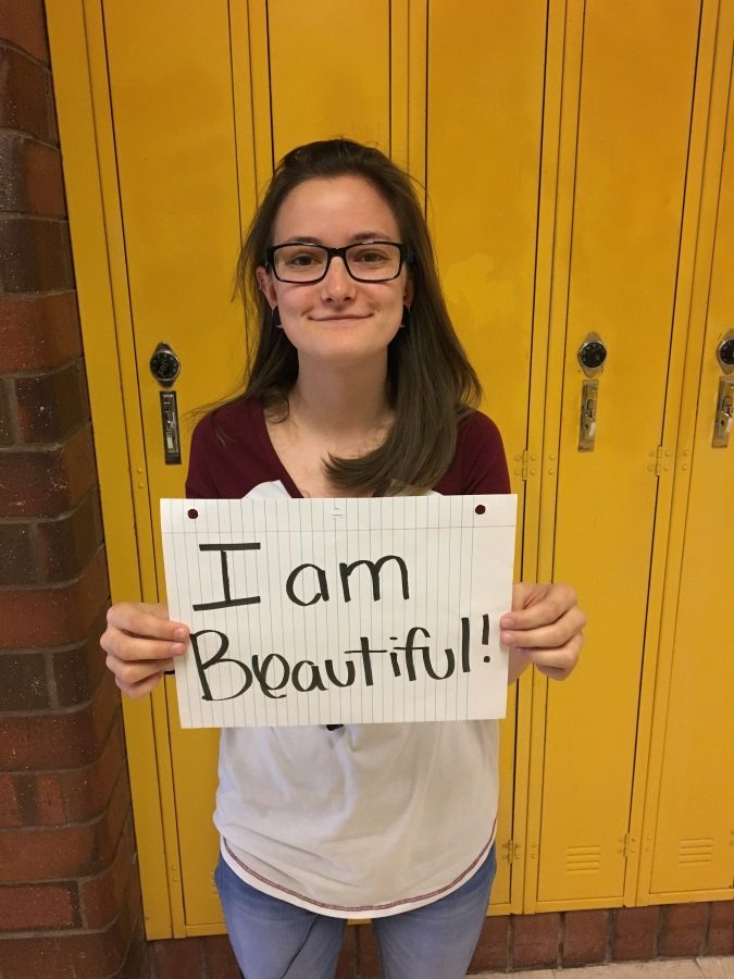 Brianna Merila embraces herself by standing proudly.
