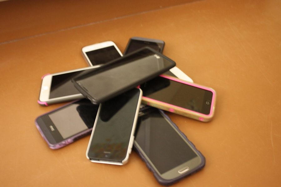 Students use phones to create a pillar of technology.
