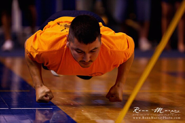 An athlete participates in the knuckle hop competition during the World Eskimo Indian Olympics in Fairbanks, Alaska