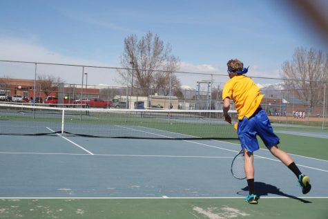 Junior, Jessie Marchant partices his serves at the tennis courts located on the East side of the school for an upcoming tennis match