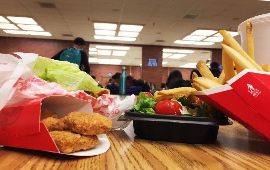 There are many options available for teenager to consume - some healthier than others. This picture depicts the two opposing options, one healthy and the other decidedly not. For students, its often cheaper to eat fast food over fresh foods. 