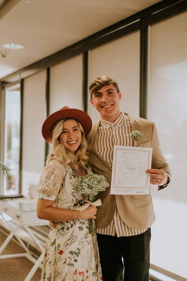 Nicole Lavely with her husband and wedding certificate.