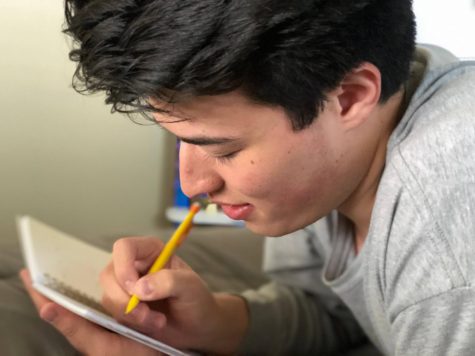Graduate Elias Hickman writing out a schedule.