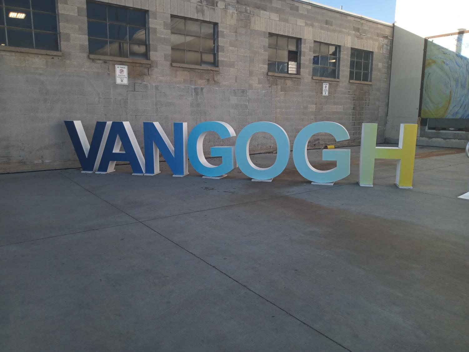 A large sign that reads Vangogh. Its an Ombré from blue to yellow.