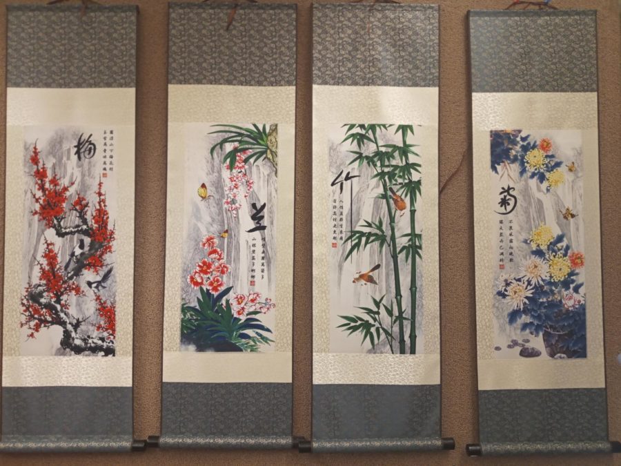 4 banners in the Chinese Language class that read plum blossom, orchid, bamboo, and chrysanthemum (left to right)