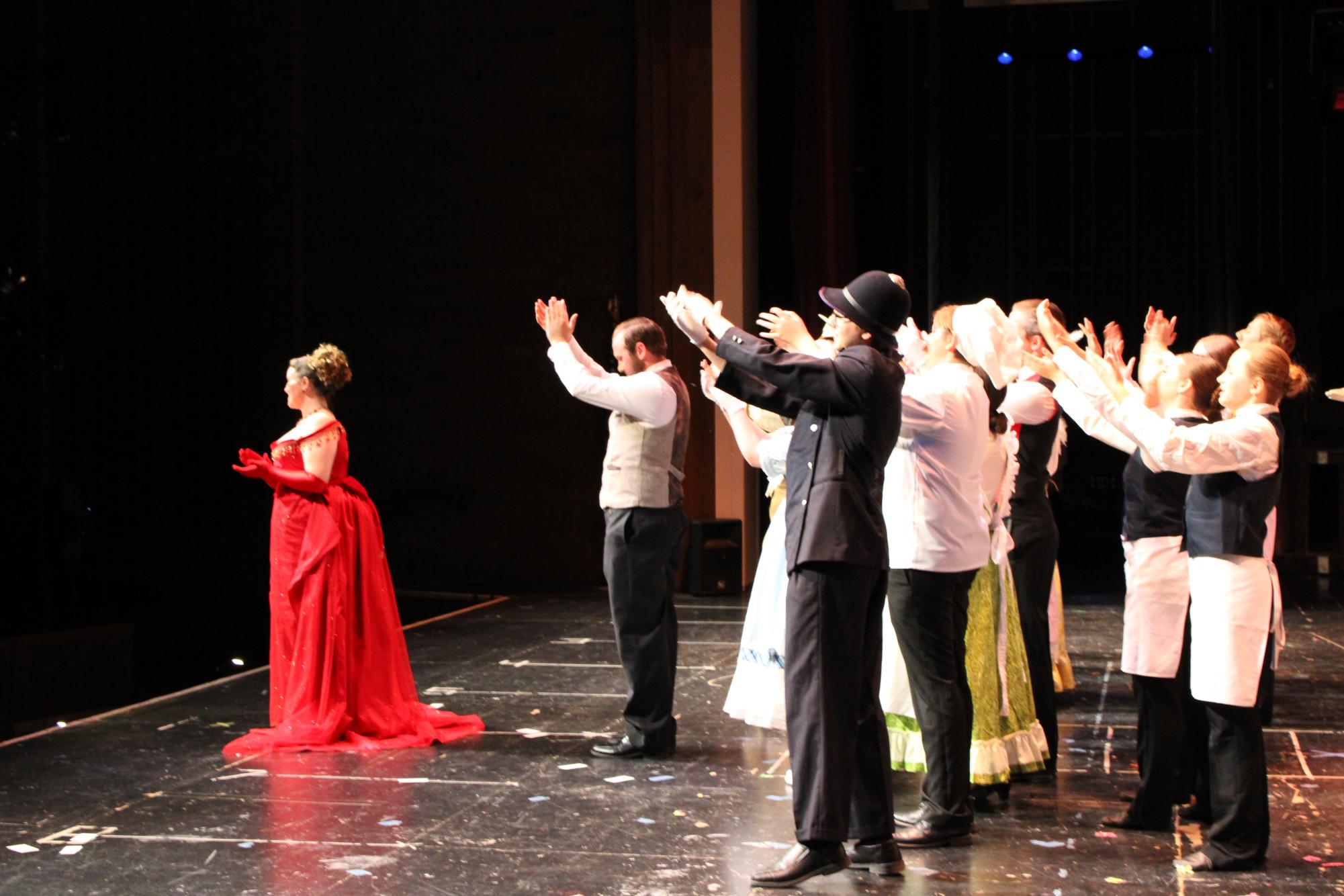 Ensemble applauses for Vivie Olson (Dolly) at an end of a performance.