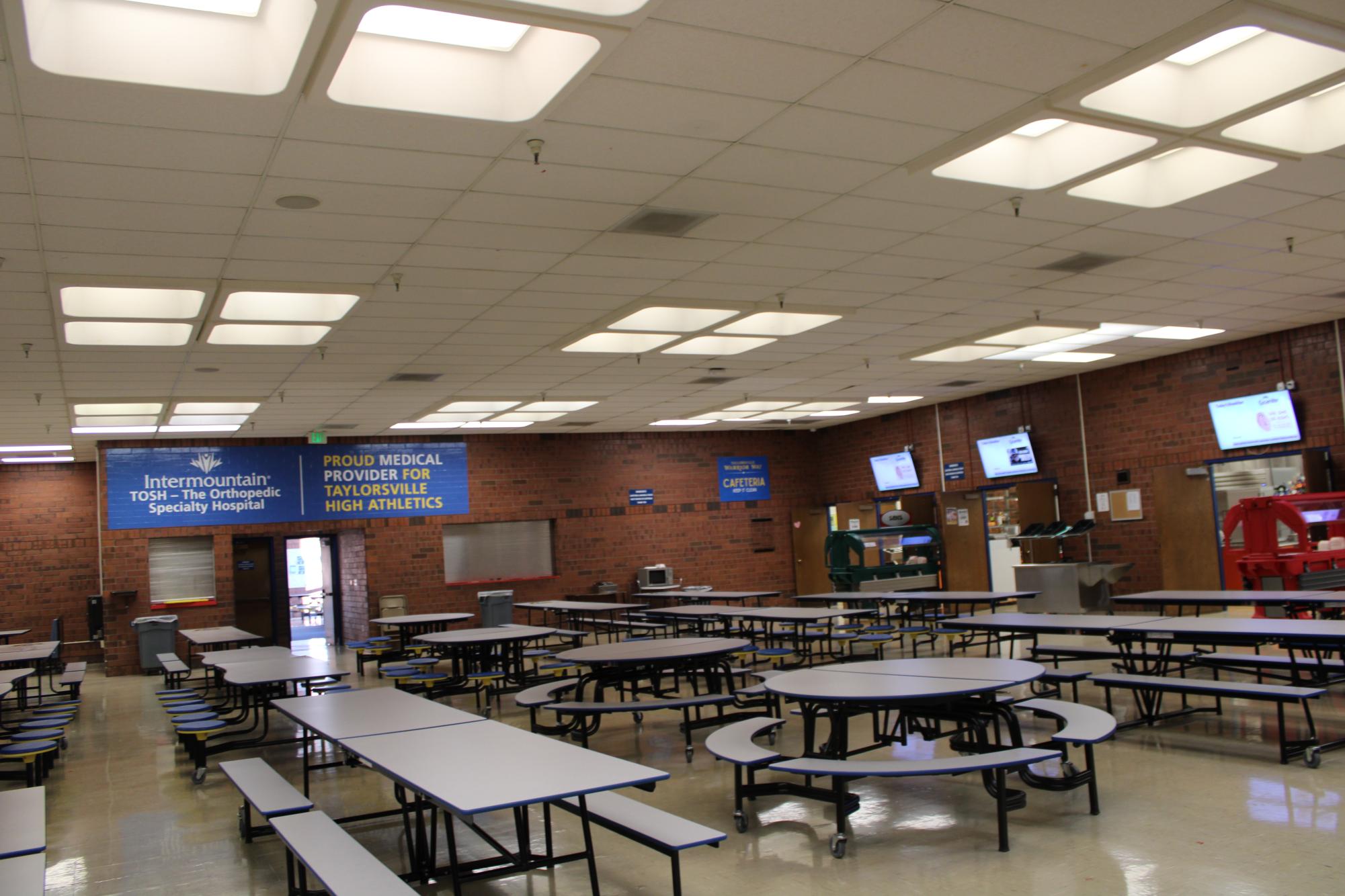 The school's cafeteria with plenty of lunchroom tables